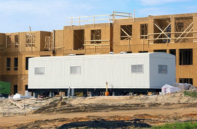 workers studying blueprints in a temporary rental office in Killeen TX